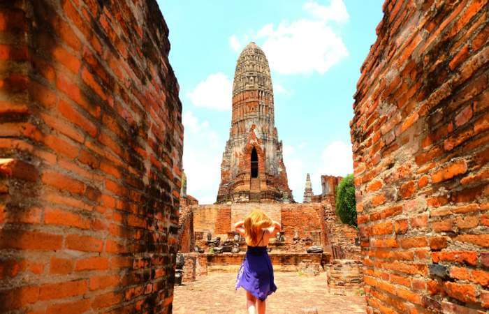 Explore the ancient ruins in Ayutthaya, Thailand, home of the famous Buddha in a Banyan Tree.
